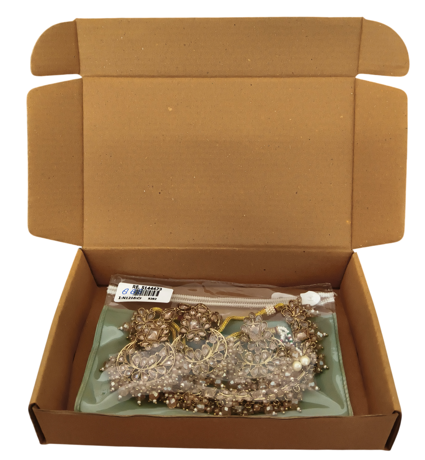 Premium artificial kundan jewelry set safely packed inside a protective zip pouch and a sturdy brown corrugated shipping box.