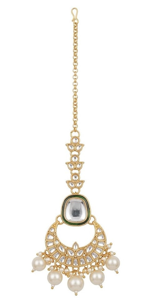 Close-up detail of the imitation clear stones, green enamel trim, and faux pearl tassels on the artificial Kundan jewelry pieces.
