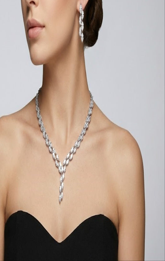 Close-up view of premium artificial Silver plated American Diamond marquise necklace and earring set on white by Innovate Art Impex.