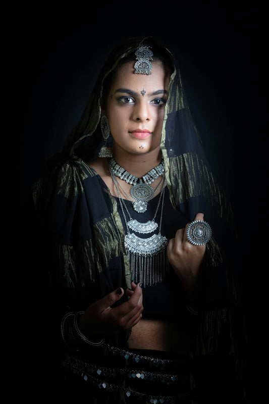 a woman in a black and gold outfit