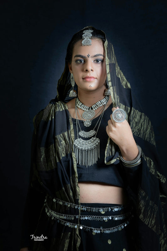 a woman in a black and gold outfit