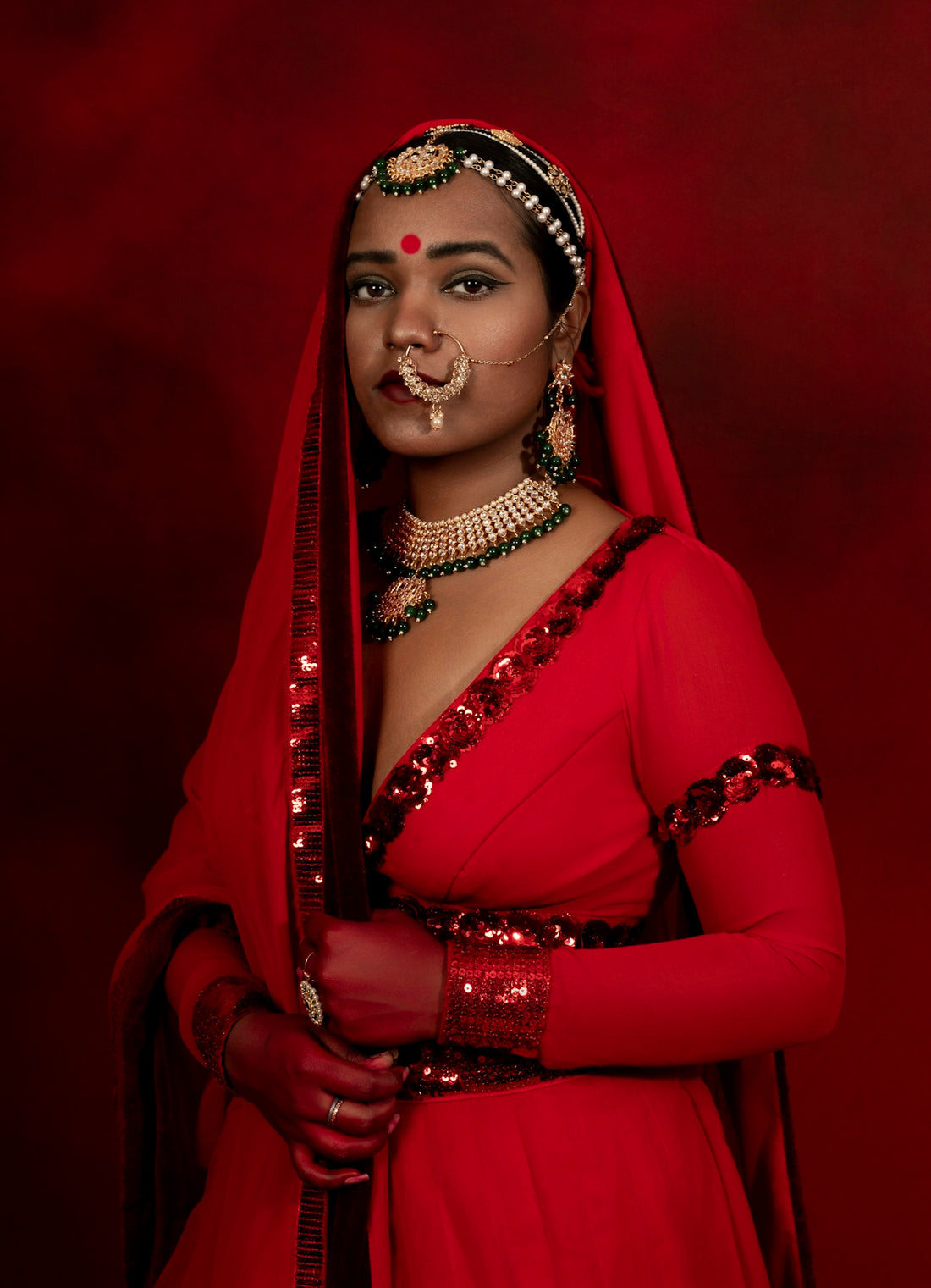a woman in a red dress with a nose ring