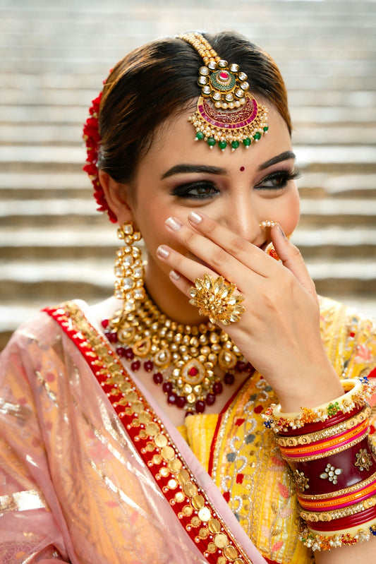A woman in a yellow and red bridal outfit
