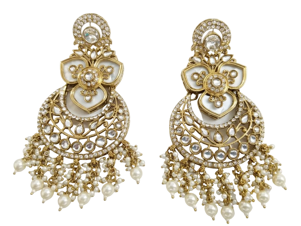 A pair of standalone imitation Kundan Chandbali earrings with a detailed gold-tone alloy frame, pure white synthetic stones, and intricate faux pearl drop clusters on a bright light background.