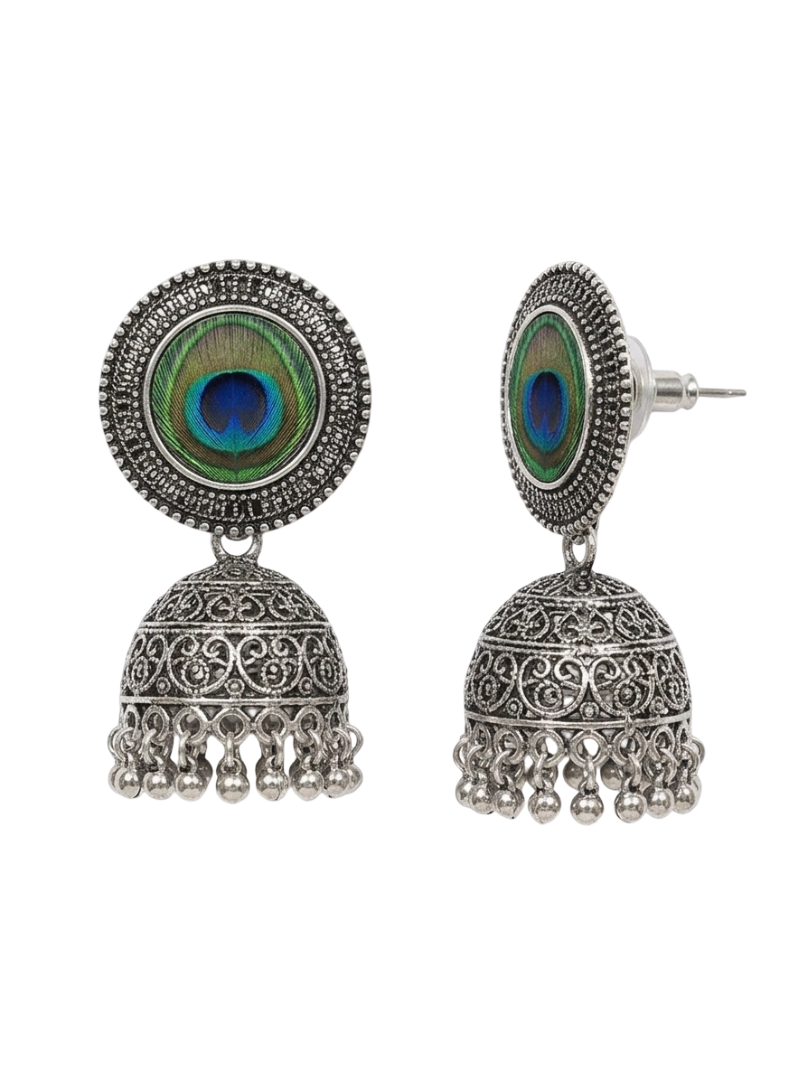 A pair of silver-toned Indian jhumka earrings with peacock feather inlay, shown from both front and side angles on a white background.