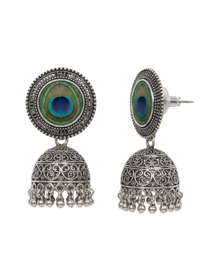 A pair of silver-toned Indian jhumka earrings with peacock feather inlay, shown from both front and side angles on a white background.