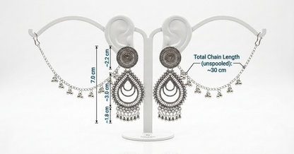 Silver-toned Indian jhumka earrings displayed on a white stand, with measurement annotations showing the total chain length and individual chain segments.