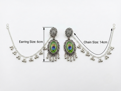 Silver-toned traditional Indian bridal jewelry set featuring a choker necklace and matching drop earrings with peacock feather inlays, annotated with size measurements of 6cm for the earring and 14cm for the chain on a white background.