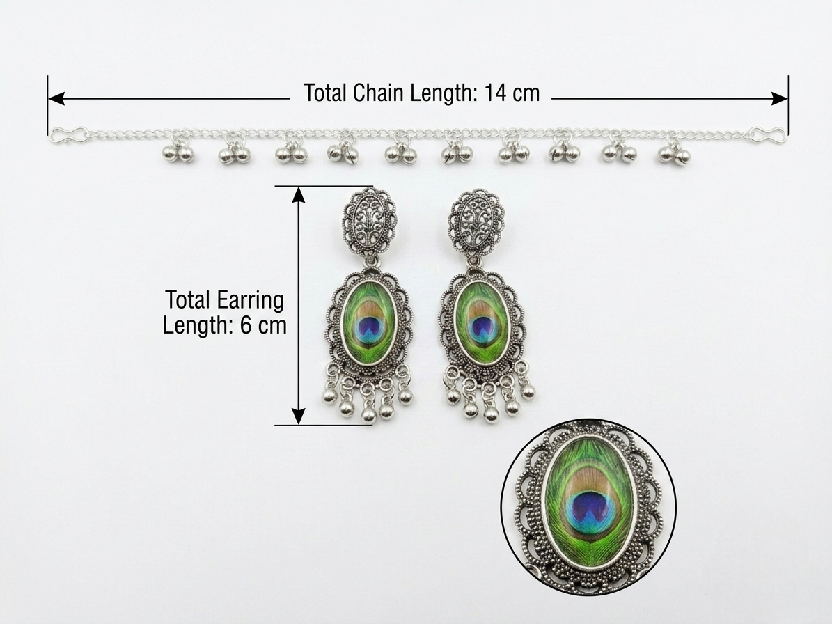 Silver-toned traditional Indian jhumka earrings with peacock feather inlays, shown with a matching chain and measurement annotations indicating a total chain length of 14 cm and total earring length of 6 cm.