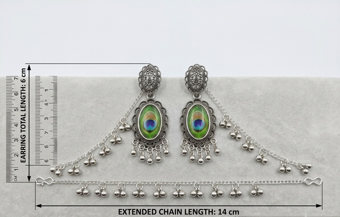 Silver-toned traditional Indian bridal jewelry set including a pair of dangle earrings and a matching chain bracelet, displayed on a light gray surface with measurement rulers indicating earring total length 6 cm and extended chain length 14 cm.