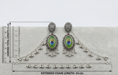 Silver-toned traditional Indian bridal jewelry set including a pair of dangle earrings and a matching chain bracelet, displayed on a light gray surface with measurement rulers indicating earring total length 6 cm and extended chain length 14 cm.