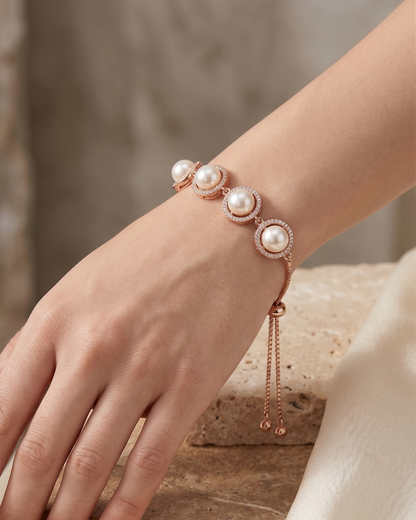 Close-up flat lay of the rose gold adjustable slider bracelet featuring cultured pearls and fine box chain.