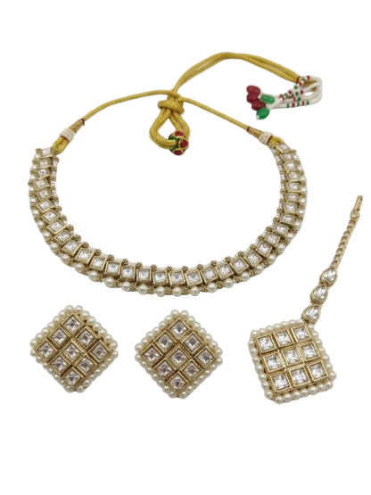 Top-down view of the Vaidika Royal Heritage Kundan choker, earrings, and maang tikka ensemble.