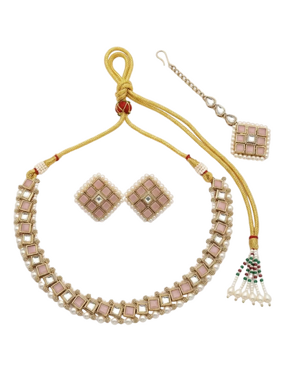 Flat lay display of a premium pink Kundan and stone choker jewelry set, featuring a gold-toned adjustable dori, square earrings, and a maang tikka on a white background.