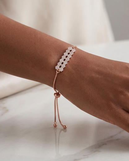 Model wearing the elegant rose gold geometric pavé bar adjustable bolo bracelet, demonstrating the beautiful drape of the box chain.