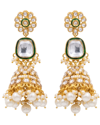 Close-up detail of the imitation clear stones, green enamel trim, and faux pearl tassels on the artificial Kundan jewelry pieces.