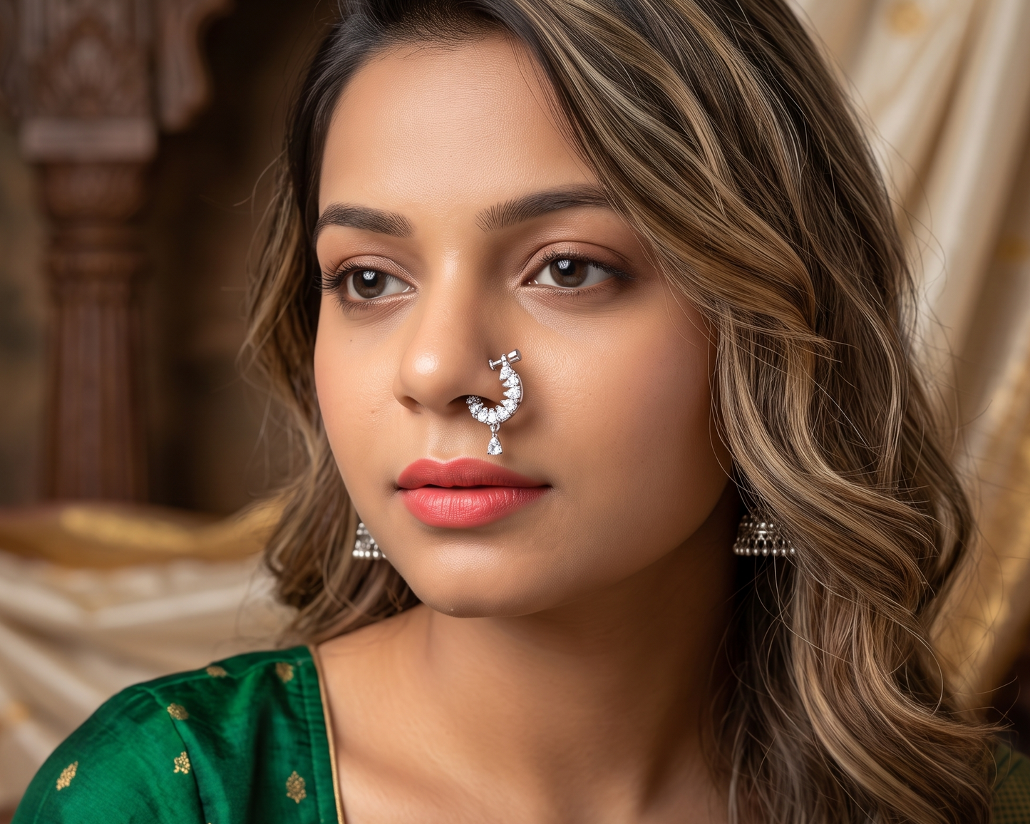 Woman wearing traditional jewelry with a decorative background