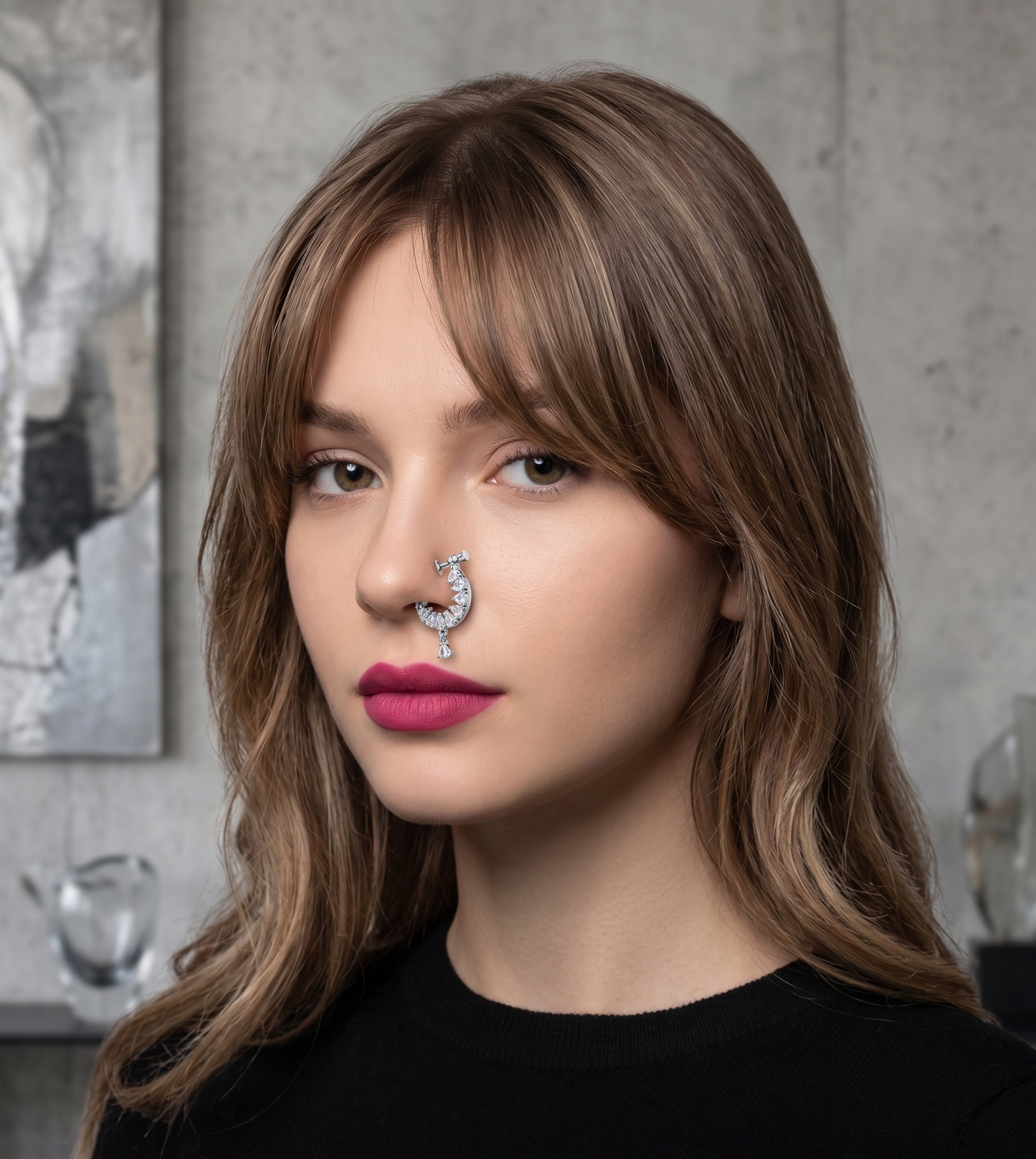 Woman with a nose ring wearing a black shirt with 'Innovate Art Impex' text.