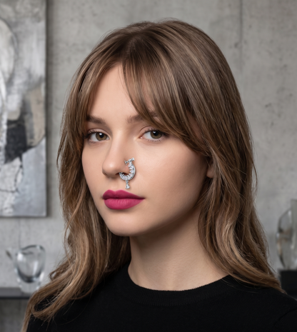 Woman with a nose ring wearing a black shirt with 'Innovate Art Impex' text.