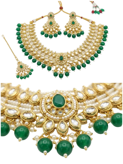 Gold and white pearl traditional Indian jewelry set with green stones, including a necklace, earrings, and a matching maang tikka, shown on a white background with a close-up detail view.